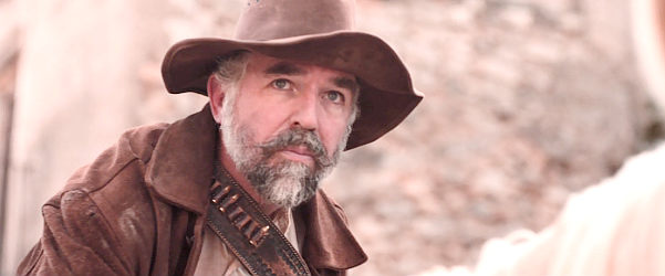 Charles Creed Miles as Cooper Ryles, one of the cruel brothers in Gunfight at Dry River (2021)