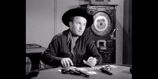 Dick Paxton as Ace Logan, a fast gun who balks at Boone's efforts to clean up Waco in Waco (1952)