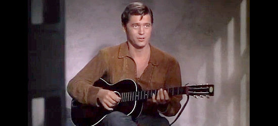 Gordon MacRae as Logan Barrett, entertaining his fellow inmates with a song in Return of the Frontiersman (1950)