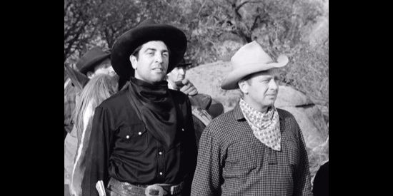 Paul Fierro as Lou Garcia and Rand Brooks as Al, members of Curly's gang, hoping they've lost the posse in Waco (1952)