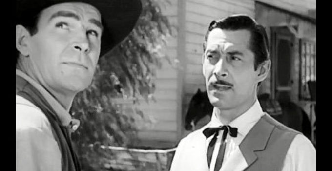 Rod Cameron as John Sands, warned to get out of town before a storm strikes by Matt Garson (Reed Haley) in Panhandle (1948)