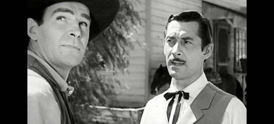 Rod Cameron as John Sands, warned to get out of town before a storm strikes by Matt Garson (Reed Haley) in Panhandle (1948)
