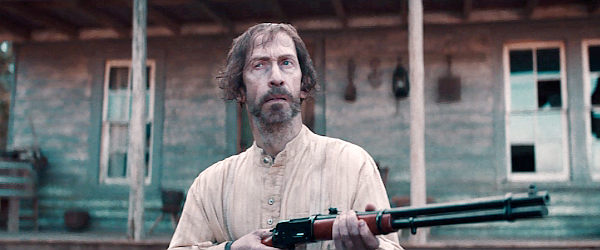 Tim Blake Nelson as Henry, rifle ready for trouble in Old Henry (2021)