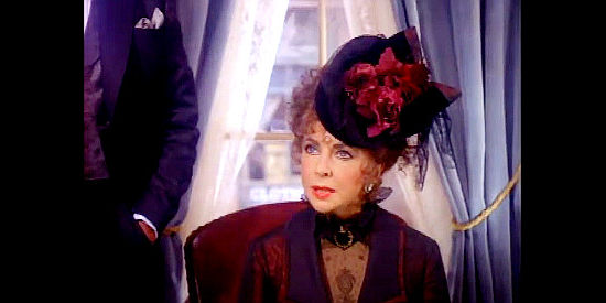 Elizabeth Taylor as Alice Moffit, confronting a bordello customer who refuses to pay one of her girls in Poker Alice (1987)