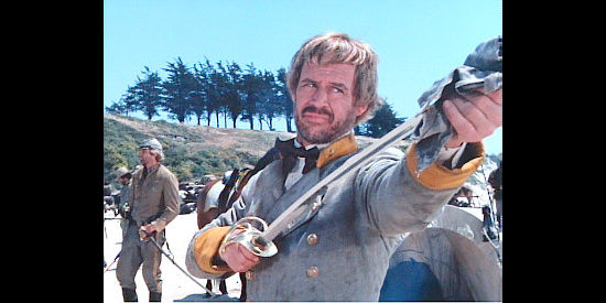 Geoffrey Lewis as Maj. Cooper Ashbury, shining his sword for the day the Confederacy rises again in Shadow Riders (1982)