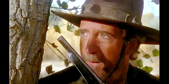 Scott Wilson as John 'Red Jack' Stillwell, waiting for a badge to step into range in The Tracker (1988)