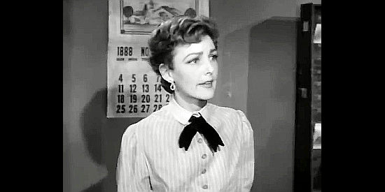 Virginia Grey as Laura Brock, sharing news of the Dentons younger brother in Three Desperate Men (1951)