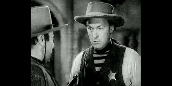 Albert Dekker as George Bird, standing up to fast gun Tod Shelby in Rangers of Fortune (1940)