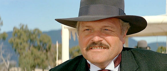 Brian Dennehy as Harrison, issuing a stay-away warning to Jim Craig in Return to Snowy River (1988)
