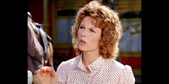 Darleen Carr as Mary Lou Springer, the lady photographer and newspaperwoman trying to interview Maverick in Bret Maverick, The Lazy Ace (1981)