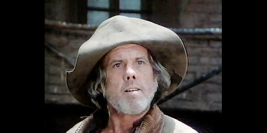 Dennis Fimple as Lamont, one of two one-armed aging miners left behind in Sweetwater in The Wild Women of Chastity Gap (1983)