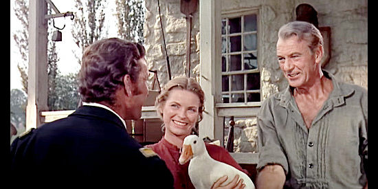 Dorothy McGuire as Eliza Birdwell with her pet goose Samantha and Gary Cooper as Jess Birdwell welcome a visitor to their home in Friendly Persuasion (1956)
