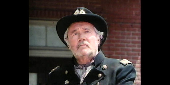 Howard Duff as Col. Samuel Isaacs, returning to Sweetwater intent on pillaging the town in The Wild Women of Chastity Gap (1983)
