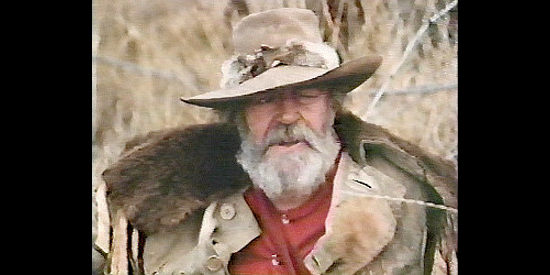 Jack Elam as Lum Witcher, the trapper who suggest Colter find a Paiute woman to care for his child in Sacred Ground (1983)