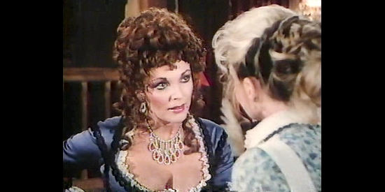 Joan Collins as Annie McCulloch, sharing some wordly knowledge with her niece in The Wild Women of Chastity Gap (1983)