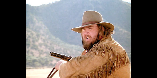 John Candy as James Harlow, ready for a showdown with Gen. Larchmont in Wagons East (1994)