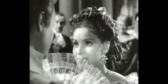 Maureen O'Hara as Carolyn Bainbridge, promising politicians kisses for votes supporting West Point in Ten Gentlemen from West Point (1942)