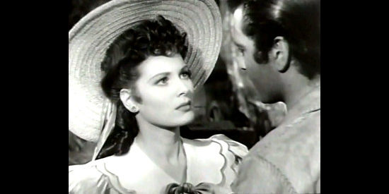 Maureen O'Hara as Carolyn Bainbridge, trying to keep Joe Dawson from returning to Kentucky in Ten Gentlemen from West Point (1942)