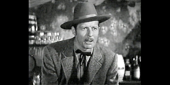 Morgan Conway as Bill Hampton, the U.S. Marshal who wants to arrest Mark Rowley in Badman's Territory (1946)
