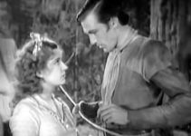 Lili Damita as Felice and Gary Cooper as Clint Belmet figuring out a future in Fighting Caravans (1931)