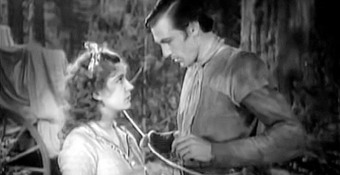 Lili Damita as Felice and Gary Cooper as Clint Belmet figuring out a future in Fighting Caravans (1931)