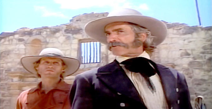 Sam Elliott as Sam Houston, questioning the wisdom of defending the Alamo as Jim Bowie (Michael Beck) looks on in Gone to Texas (1986)