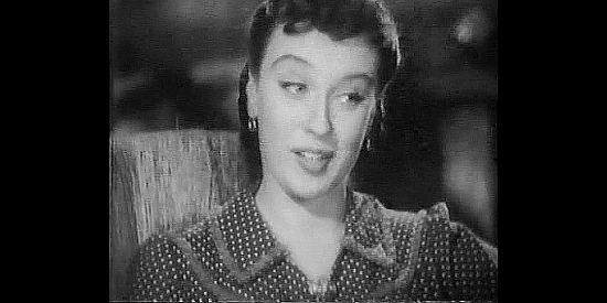 Patricia Morison as storekeeper Sharon McCloud, learning about the three new men in town from Squib Clayborn in Rangers of Fortune (1940)