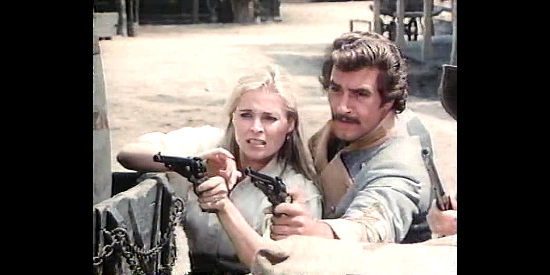 Prisilla Barnes as Maggie McCulloch and Lee Horsley as Capt. Cain, helping fight off the Union renegades in The Wild Women of Chastity Gap (1983)