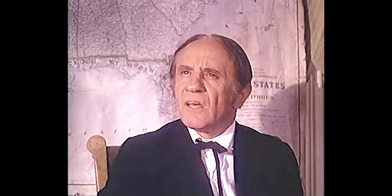 Sam Kirbens as Judge Melville B. Gerry, sentencing Packer to hang for eating Democrats in The Legend of Alfred Packer (1980)