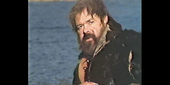 Tim McIntire as Matt Colter, watching the Paiute destroy his home while his son is born in Sacred Ground (1983)