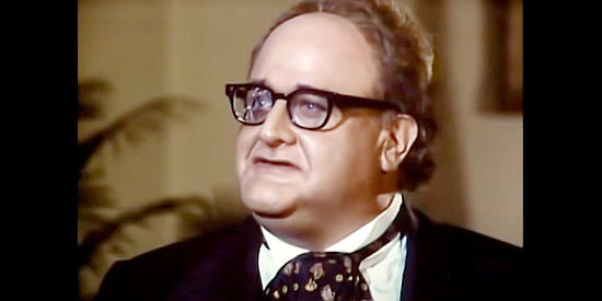 Victor Buono as Dr. Henry Messenger, presiding over a not very peaceful peace conference in More Wild, Wild West (1980)