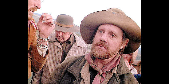 William Sanderson as Zeke, trying in vain to remember the scandal in Harlow's past in Wagons East (1994)