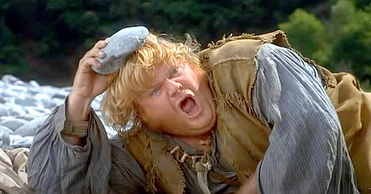 Chris Farley as Bartholomew Hunt, ducking for cover as the conquistadors catch up with the expedition in Almost Heroes (1998)