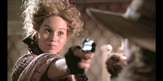 Christina Applegate as Lurline Newcomb, pulling a derringer on a rude customer in Wild Bill (1995)