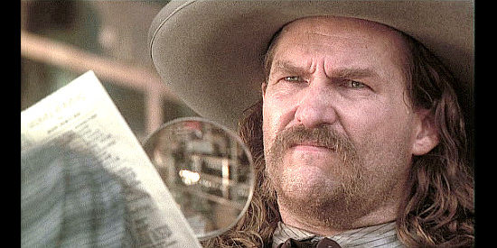Jeff Bridges as Wild Bill Hickok, forced to use a magnifying glass because of his fading eyesight in Will Bill (1995)