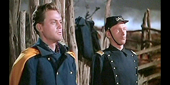 John Agar as Lt. Flint Cohill and Harry Carey Jr. as Lt. Ross Pennell, caught arguing over Olivia in She Wore a Yellow Ribbon (1949)