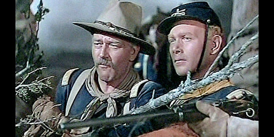 John Wayne as Capt. Brittles and Harry Carey Jr. as Lt. Ross Pennell, watching Indians torture a gunrunner in She Wore a Yellow Ribbon (1949)