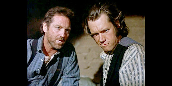 Larry Gatlin as Gale Taggart and Randy Travis as Phoenix Taggart, plotting to get their share of the loot in Outlaws, The Legend of O.B. Taggart (1995)