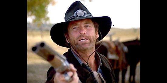 Larry Gatlin as Gale Taggart, gun ready and standing up for the Taggarts again in Outlaws, The Legend of O.B. Taggart (1995)