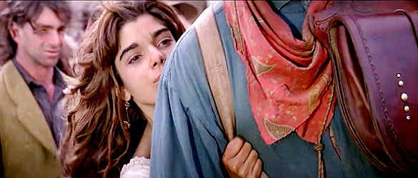 Laura San Giacomo as Crazy Cora, hiding behind Quigley as fists start flying in Quigley Down Under (1990)