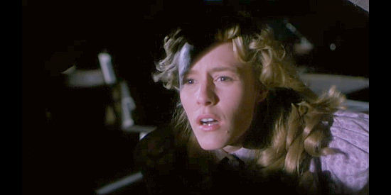Mary Stuart Masterson as Jenny Hill, watching through a loft window as her husband transforms in Mad at the Moon (1992)