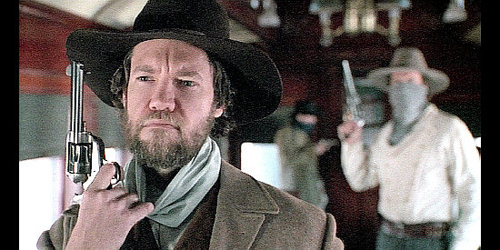 Randy Travis as Cole Younger, coming face to face with Alan Pinkerton in Frank and Jesse (1994)