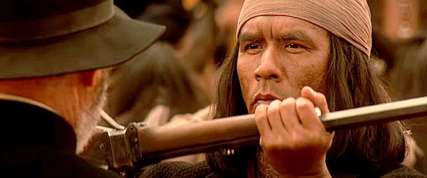 Wes Studi as Geronimo, turning over his rifle to Brig. Gen. George Crook in a sign of surrender in Geronimo, An American Legend (1993)