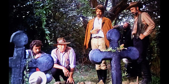 Alex Cord as Cal Kincaid and his companions, at the graves of the Straulle's children in Inn of the Damned (1975)