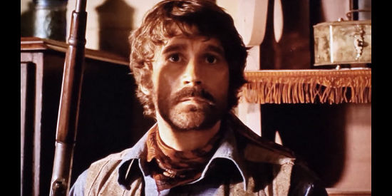 Alex Cord as Cal Kincaid, lying in wait for a suspected killer in Inn of the Damned (1975)