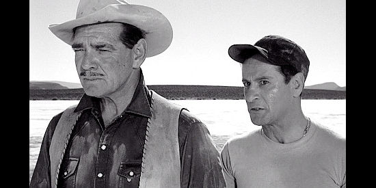 Clark Gable as Gay Langland and Eli Wallach as Guido, watching Roslyn make a fuss over captured horses in The Misfits (1961)