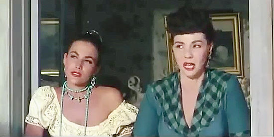 Mara Corday as Moccasin Mary and a fellow saloon girl check out the latest cowboy offering to trade a saddle for companionship in Man Without a Star (1955)