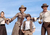 Joanna Pettet as Maggie Sergeant and William Shatner as husband John, celebrating their arrival in Wyoming with their children in Pioneer Woman (1973)