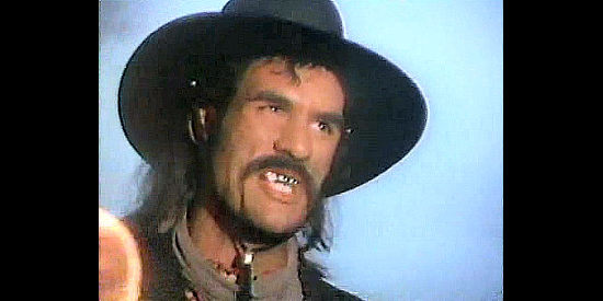 Robert Davi as William Quantrill, ordering that John Golden be driven off a cliff in The Legend of the Golden Gun (1979)