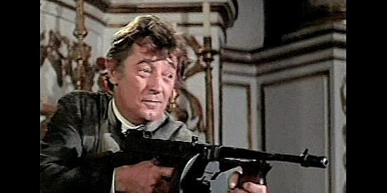 Robert Mitchum as Father Oliver Van Horne, showing off his secret weapon in The Wrath of God (1972)